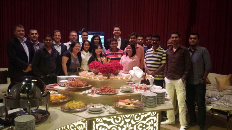 Xeratek employees standing around a table with food