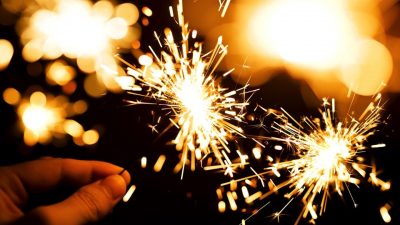 a hand holding a sparkler