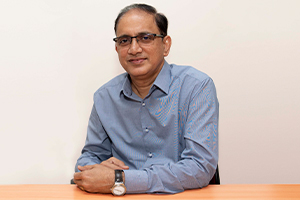 Technical Engineer Placid Ribeiro sitting at a desk