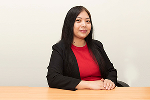 Sales Administrator Regina Gerundio sitting at a table