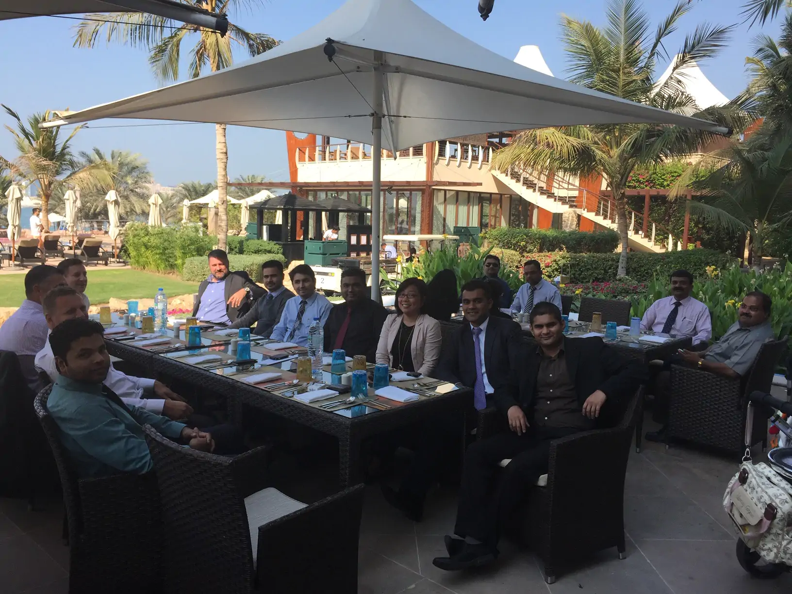 Team seated around a long table at an outdoor resort